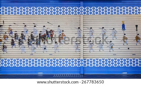 HIMEJI, JAPAN - OCTOBER 25: Painting on a Rolling Shutter in Himeji, Japan on October 25, 2014. A painting of a parade of Japanese noble painted on a rolling shutter of a Japanese shop