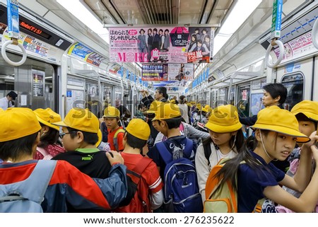 OSAKA, JAPAN - OCTOBER 28: Japanese Students in Osaka, Japan on October 28, 2014. Unidentified Japanese students on a train to a field trip