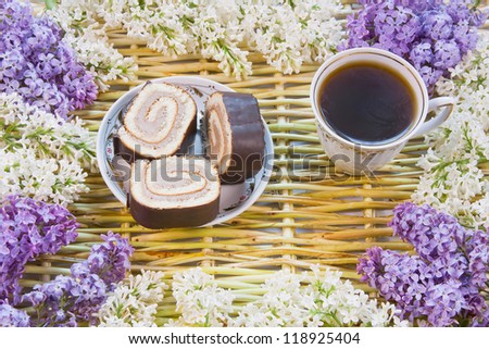 designer background from the twigs of willow, flowers  of lilac, cup of coffee and meat loaf