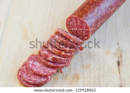 long loaf the smoked sausage on a wooden surface