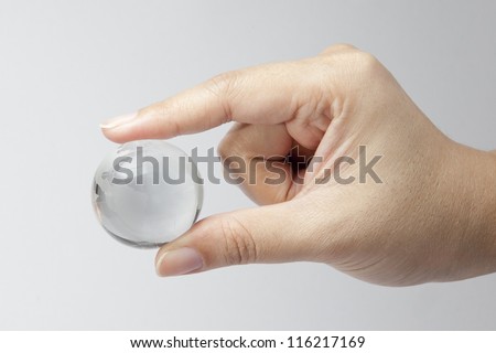 Male hand holding glass sphere in hand