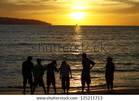 A group of friends and sunset silhouette in Sabah