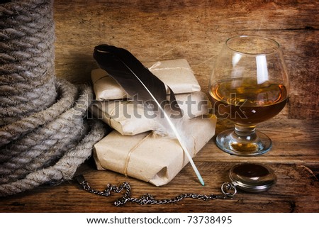 A glass of wine with postal supplies against the old wooden boards