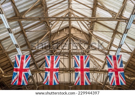 Four 'Union Jacks' hanging from the roof top in London's Victoria Station