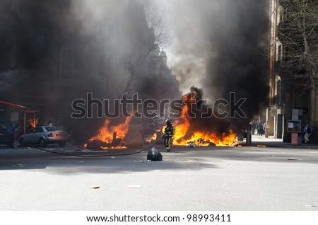 BARCELONA, SPAIN - MARCH 29: One of the multiple fires caused by heavy riots during nationwide spanish general strike against labour reforms in the city center of Barcelona on March 29, 2912.
