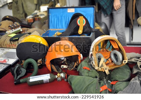 MILAN, ITALY - NOV 1: Airline pilots helmets, Exhibitor sitting in his stand at Militalia, exhibition dedicated to militaria collectors and military associations on November 1, 2014 in Milan.