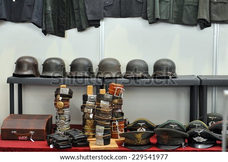MILAN, ITALY - NOV 1: Military helmets, Exhibitor sitting in his stand at Militalia, exhibition dedicated to militaria collectors and military associations on November 1, 2014 in Milan.