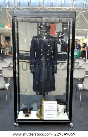 MILAN, ITALY - NOV 1: Uniform, Exhibitor sitting in his stand at Militalia, exhibition dedicated to militaria collectors and military associations on November 1, 2014 in Milan.