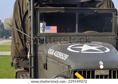 MILAN, ITALY - NOV 1: Old military truck, Exhibitor sitting in his stand at Militalia, exhibition dedicated to militaria collectors and military associations on November 1, 2014 in Milan.