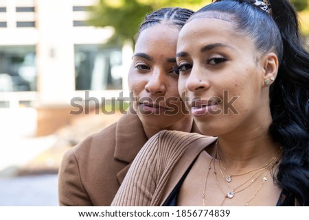 Young African American lesbian couple close together