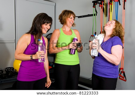 woman drinking water at a gym