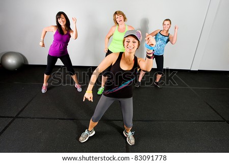 An aerobics and dance class for women at a gym.