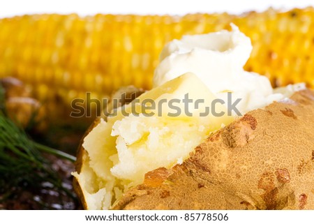 Butter and sour cream on baked potato