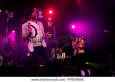 SEATTLE - APRIL 8: Lead singer Sameer Gadhia of alternative rock band Young the Giant performs on stage at the Moore Theater in Seattle, WA on April 8, 2012.