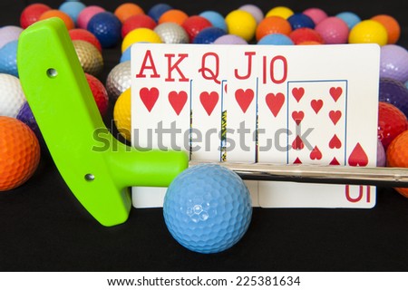 Royal flush poker hand with mini golf putter and balls