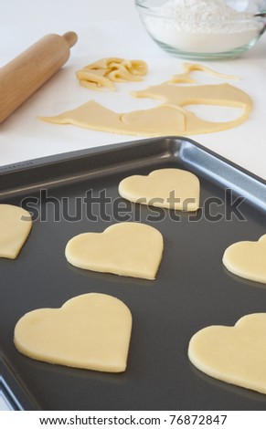 Heart shaped cookies on a pan ready to be cooked
