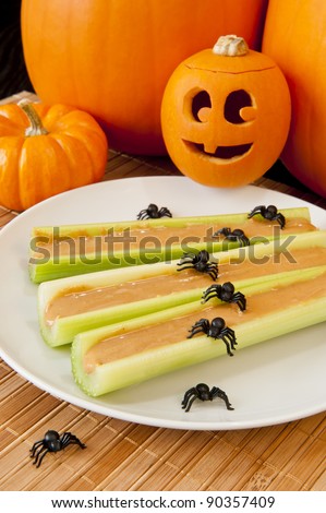 Celery sticks with peanut butter, a smiling jack-o-lantern and spiders