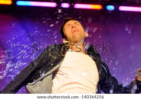BARCELONA - MAY 24: Damon Albarn, frontman of Blur band, throws water during his concert at Heineken Primavera Sound 2013 Festival on May 24, 2013 in Barcelona, Spain.