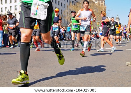 BARCELONA - MAR 16: People run in the Zurich Barcelona Marathon through the streets of the city on March 16, 2014 in Barcelona, Spain.