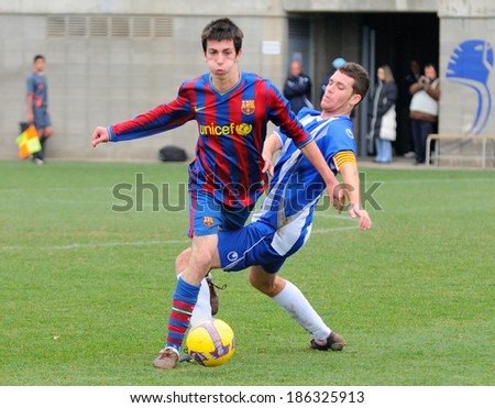 BARCELONA - DEC 13: Isaac Cuenca (left), F.C. Barcelona youth team player, in action against RCD Espanyol on December 13, 2009 in Barcelona, Spain.