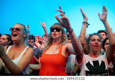 BENICASIM, SPAIN - JULY 19: Women from the crowd (fans) watch a concert at FIB  Festival on July 19, 2013 in Benicasim, Spain.