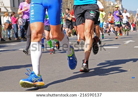 BARCELONA - MAR 16: People run in the Zurich Barcelona Marathon through the streets of the city on March 16, 2014 in Barcelona, Spain.