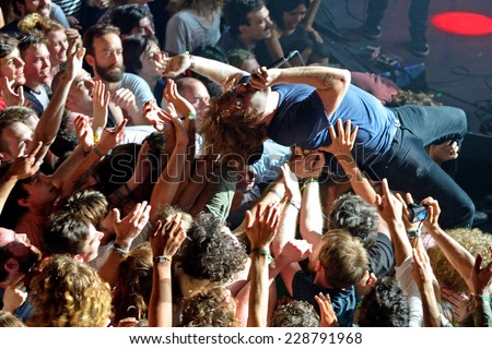 BARCELONA - MAY 30: The guitar player of Ty Segall (band) performs above the spectators (crowd surfing or mosh pit) at Heineken Primavera Sound 2014 Festival on May 30, 2014 in Barcelona, Spain.