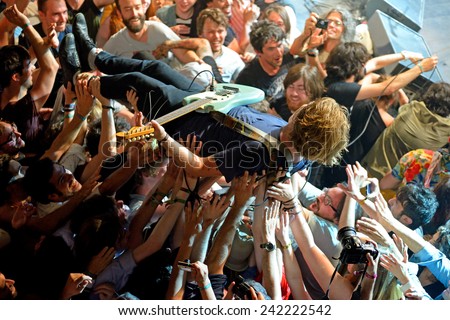 BARCELONA - MAY 30: The guitar player of Ty Segall (band) performs above the spectators (crowd surfing or mosh pit) at Heineken Primavera Sound 2014 Festival on May 30, 2014 in Barcelona, Spain.