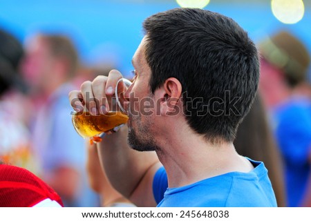 BENICASSIM, SPAIN - JULY 19: A man from the crowd drinks a glass of beer at FIB (Festival Internacional de Benicassim) 2013 Festival on July 19, 2013 in Benicassim, Spain.