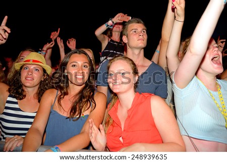 BENICASSIM, SPAIN - JULY 19: Women watch a concert in the crowd at FIB Festival on July 19, 2014 in Benicassim, Spain.