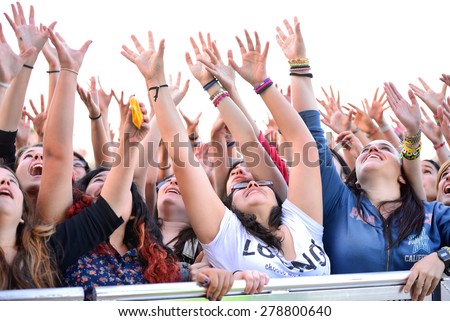 BARCELONA - MAY 23: Girls from the audience in front of the stage, cheering on their idols at the Primavera Pop Festival of Badalona on May 18, 2014 in Barcelona, Spain.