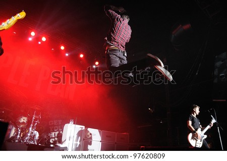 BARCELONA, SPAIN - MARCH 13: Pierre Bouvier, frontman of Simple Plan band, jumps at Razzmatazz on March 13, 2012 in Barcelona, Spain. The band is currently on their \