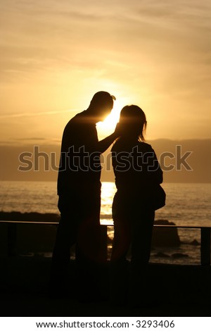 sunset couple - hand in her head