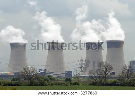 A coal fired power station with smoke pouring from cooling towers