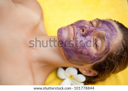 Young beautiful woman in spa making face treatment