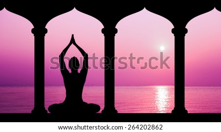 Silhouette of woman making yoga in sunset, staying in temple near the sea
