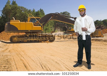 Black African American male construction worker a job site with a backhoe