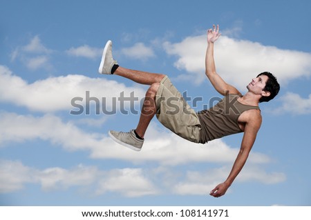 Handsome young man falling through the sky