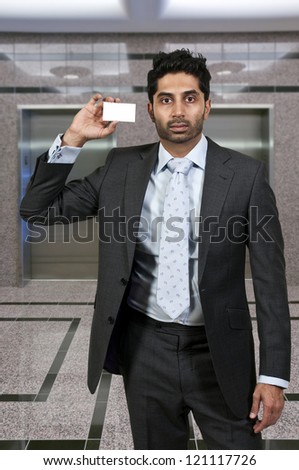 Handsome man holding up a business card