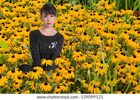 Black woman with the common wild flower known as a Black eyed Susan.