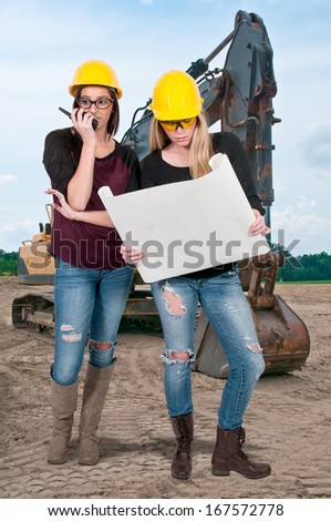 Female Construction Worker wearing a hard hat and safety glasses