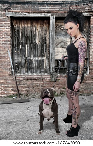 Beautiful young woman with her pit bull dog