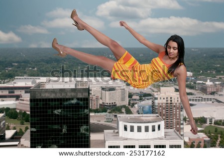Beautiful young woman falling through the sky