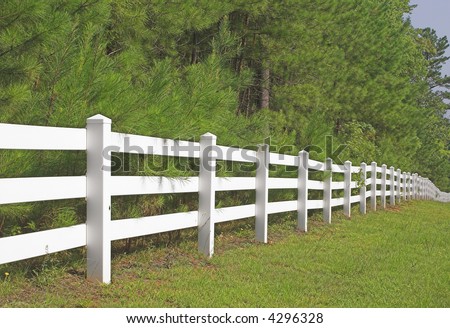 A decorative white split rail fence.