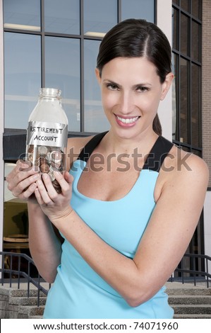 A beautiful woman holding her retirement account of coins in a milk bottle