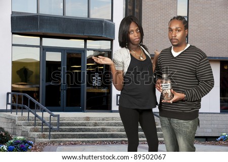 African American black couple holding a retirement account of coins in a milk bottle