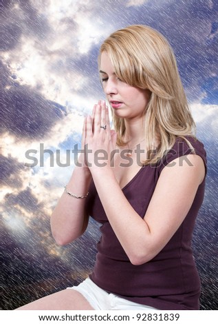 Beautiful Christian woman in a deep prayer