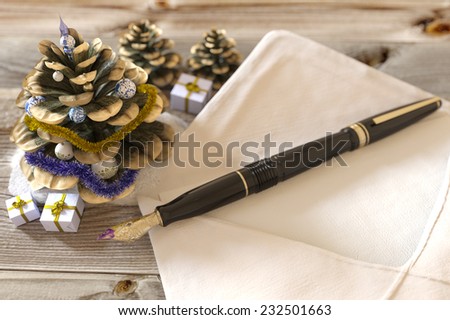 Christmas cone with gifts,pen and letter greetings holiday concept