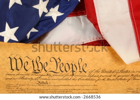 United States Constitution with American Flag Draped over the edge