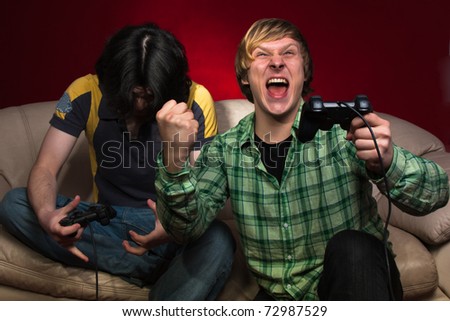 Good friends playing video games on a red background